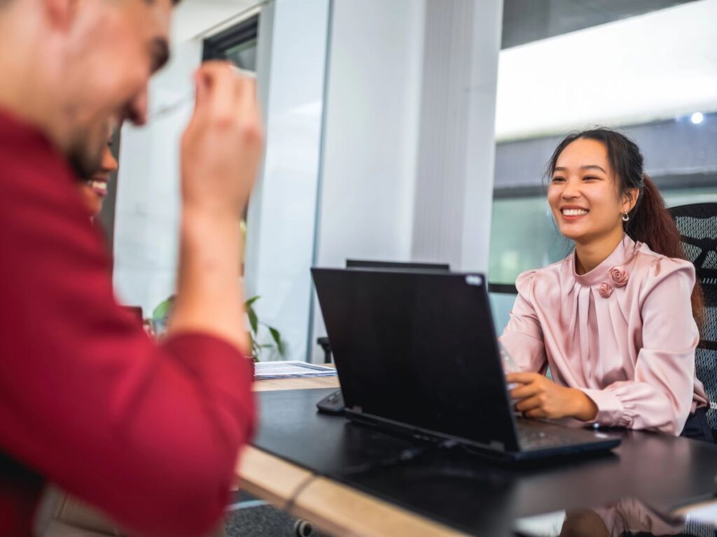 Accountant discussing financial services with a client during an office consultation.